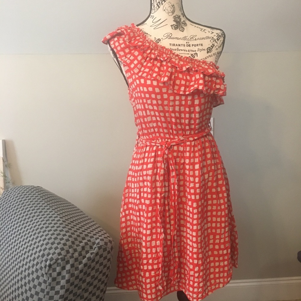 One shoulder ruffled orange dress.